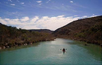 A paddler floats along the Devil's River on February 17, 2023, near Del Rio, Texas.