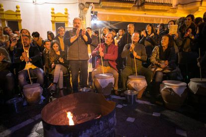 Singing around a fire at a zambomba celebration.