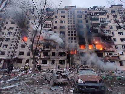 Fireighters work to extinguish a fire in an apartment building hit by shelling in the Obolon district of Kyiv. 