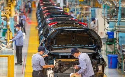 Workers assemble cars at the FAW Haima Automobile plant in China’s Hainan province.