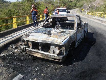 A burned vehicle following Monday's shootout in Jalisco, Mexico between traffickers and police.