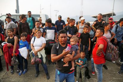 A group of Cuban migrants stand beside a road in Huixtla, a municipality in the South of Mexico, after their buses were stopped by the authorities.