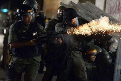 National Guard troops fire tear gas at demonstrators in Caracas.