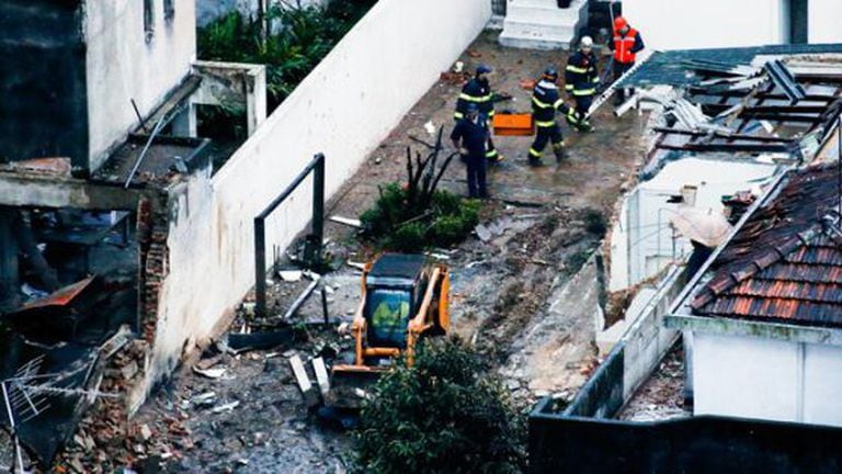 Firefighters inspect the area where the aircraft came down.