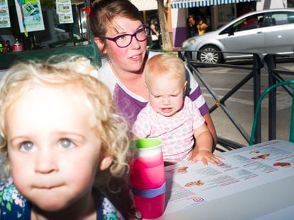 Katie DeCarie, from San Francisco. is pictured with her daughter and a friend's child, having brunch at a cafeteria named Great Day Coffee.