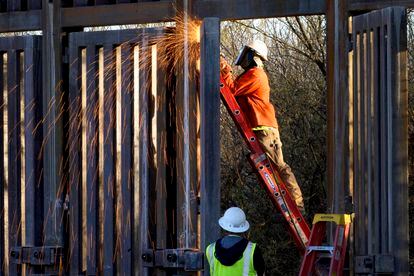 Crews construct a section of border wall in San Bernardino National Wildlife Refuge, Tuesday, Dec. 8, 2020, in Douglas, Ariz