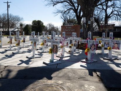 Memorial crosses stand in front of Robb Elementary School, as U.S. Attorney General Merrick Garland