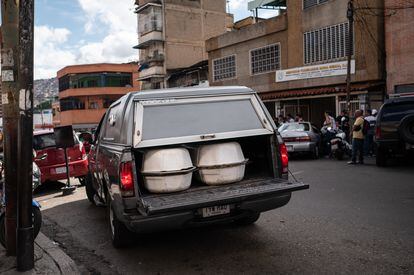 A hearse transports two coffins in Caracas' Catia neighborhood.