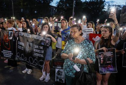 People take part in a commemoration ceremony in front of the former Russian embassy in Kyiv, Ukraine, on July 29, 2023.