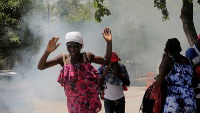 People move away from tear gas fired by officers of the Haitian National Police while clearing a camp of people escaping the threat of armed gangs, in front of the U.S. Embassy, in Port-au-Prince, Haiti July 25, 2023.