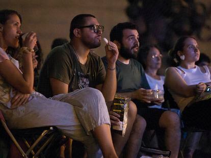 People eating during an open-air screening in Barcelona.