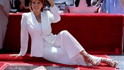 Actress Raquel Welch poses for photographers in front of her star on the Hollywood Walk of Fame along Hollywood Boulevard during ceremonies in a file photo.