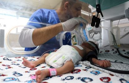 A health worker with a premature Palestinian baby lying in an incubator in the maternity ward of Al Shifa Hospital on October 22.