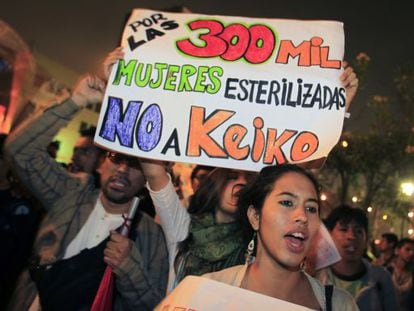 People hold a sign reading: &quot;For the 300,000 sterilized women, no to Keiko&quot; before the 2011 elections. 