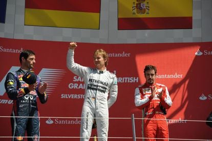 Nico Rosberg (C) celebrates his victory beside second placed Mark Webber (L) Fernando Alonso (R).