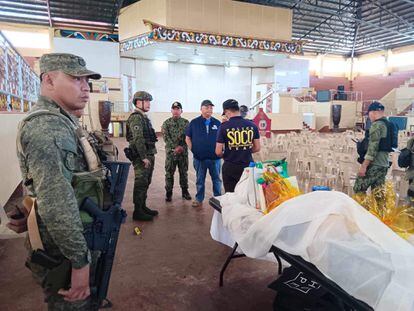 Law enforcement officers investigate the scene of an explosion that occurred during a Catholic Mass in a gymnasium at Mindanao State University in Marawi, Philippines, December 3, 2023.