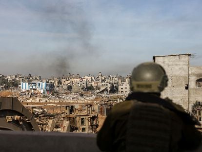 An Israeli soldier observes the destruction caused by the military offensive in Gaza City, on January 8.