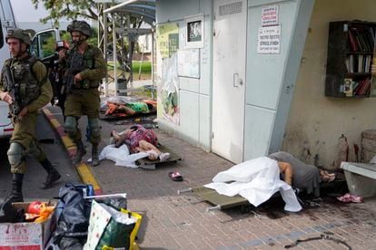 Israeli soldiers pass civilians killed on the streets of Sderot.
