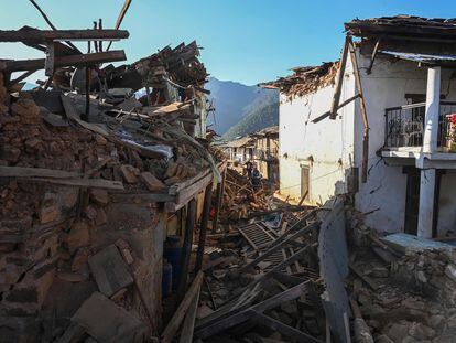 Residents walk amid the rubble of damaged homes in Jajarkot district on November 4, 2023, following an overnight a 5.6-magnitude earthquake.
