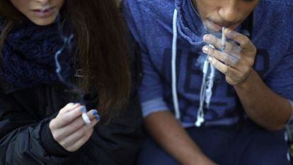 A 15-year-old girl smokes alongside her 17-year-old friend in Madrid.