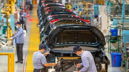 Workers assemble cars at the FAW Haima Automobile plant in China’s Hainan province.