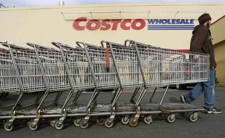 A Costco employee pulls shopping carts at a US branch of the store.