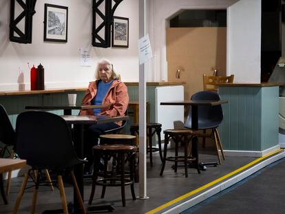 A woman sits alone in a Cardiff coffee shop.