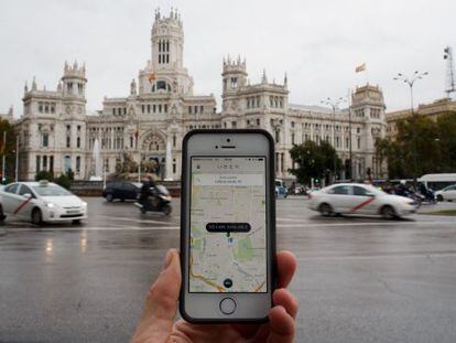 A smartphone running the Uber app in central Madrid.