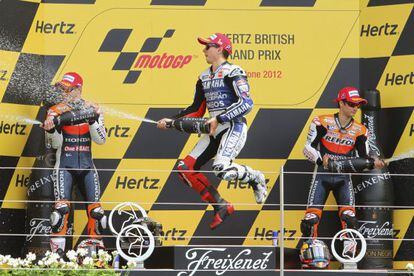 Jorge Lorenzo (c) celebrates his MotoGP win at Silverstone with Casey Stoner (l) and Dani Pedrosa. 