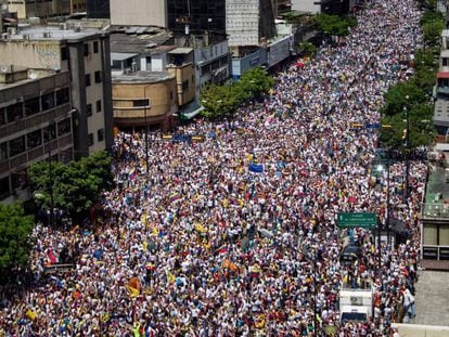 Thousands of people march on the streets of Caracas.