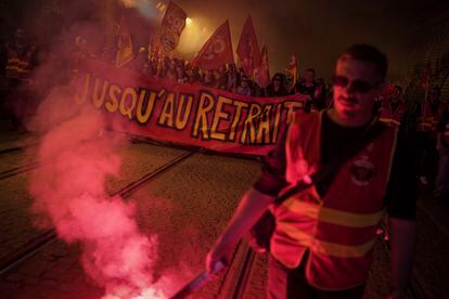 Railway workers hold a banner reading 'Until withdrawal' during a demonstration in Lyon, central France on March 22.