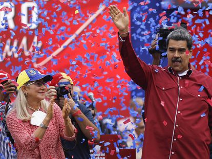 Venezuelan President Nicolas Maduro (R) and his wife Cilia Flores greet workers taking part in a demonstration to commemorate May Day (Labor Day) in Caracas, on May 1, 2023.