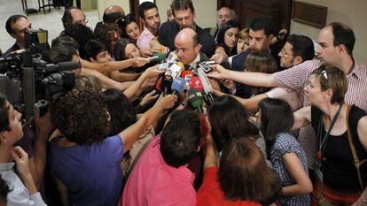 Finance Minister Luis de Guindos is mobbed by reporters after meeting with his French counterpart Wednesday.