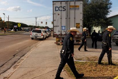 Bexar County Sheriff Javier Salazar, far right, and other officers walk away after briefing the media at the scene where an 18-wheeler was searched in the 2000 block of South General McMullen in San Antonio .