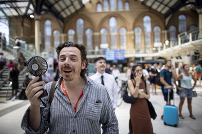 A portable fan provides some relief on the London Underground. 