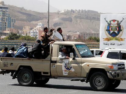 Houthi supporters ride a vehicle driving through a street in Sana'a, Yemen, 03 January 2024.