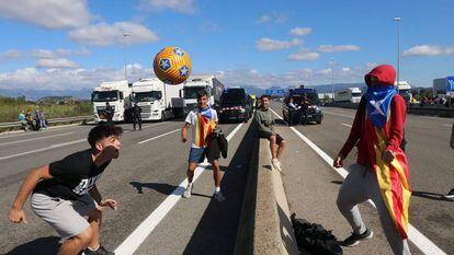 An impromptu soccer game on the C-25 road near Gurb, Catalonia on Tuesday.