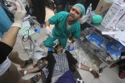 A health worker attends to a wounded man at a hospital in Rafah, January 23.