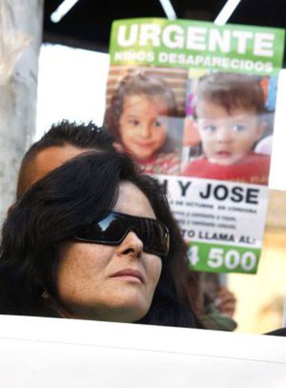 Ruth Ortiz, pictured in front of a poster of her missing children, Jos&eacute; and Ruth.