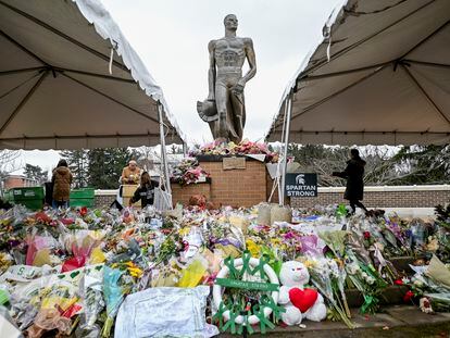 Volunteers work to clean up the memorial site at the Michigan State University campus on March 2, 2023, in East Lansing, Michigan.