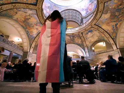 Glenda Starke wears a transgender flag as a counter protest during a rally in favor of a ban on gender-affirming health care legislation, March 20, 2023, at the Missouri Statehouse in Jefferson City.