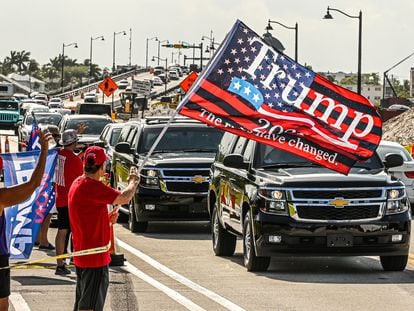 A motorcade, with former president Donald Trump on board, passes supporters in West Palm Beach, Florida, on April 1, 2023.