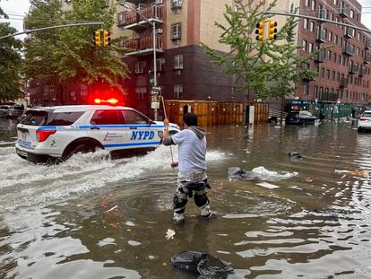 A man tries to clear a drain amid flooding last week in Brooklyn, New York.