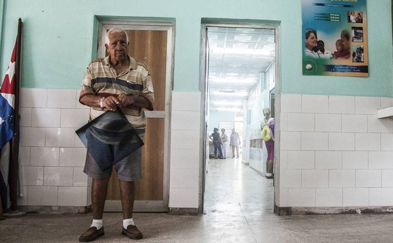 A patient waits with his X-Ray to see a doctor in the 18 October hospital in Havana.