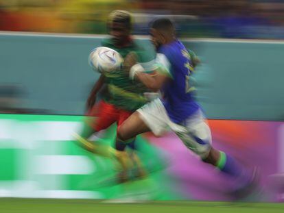 Brazilian soccer player Gleison Bremer and Cameroonian Ngom Mbekeli chase down a ball, during a match from the World Cup in Qatar, in December of 2022.