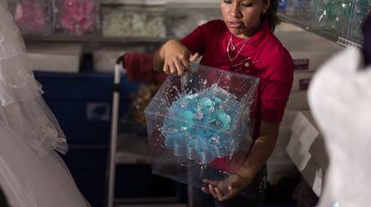 A saleswoman shows off a bouquet for Quinceañera parties.