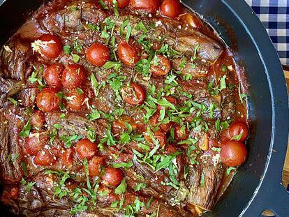 Baked eggplant with tomato and parsley.