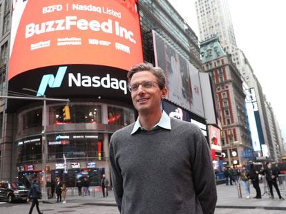 In this file photo taken on December 06, 2021 founder and CEO of BuzzFeed Jonah H. Peretti poses in front of BuzzFeed screen on Times Square during BuzzFeed Inc.'s Listing Day at Nasdaq in New York City