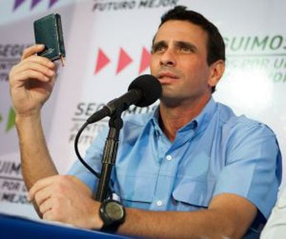 Venezuelan opposition leader Henrique Capriles holds a copy of the Constitution on Tuesday.