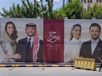 A poster with pictures of Crown Prince Hussein and his fiancee, Saudi architect Rajwa Alseif is posted at a road in Amman, Jordan, Wednesday, May 31, 2023.